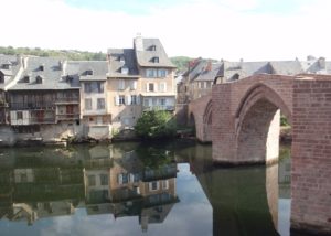 Ancient tanneries and a stone bridge reflected in the river