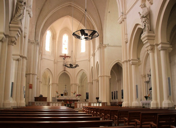The interior of the parish church with gleaming white marble walls and columns