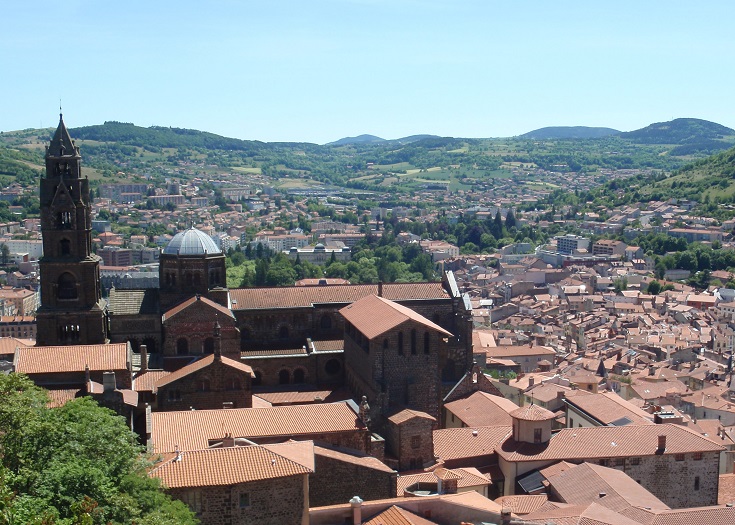 View over the cathedral and house rooftops to the green hills where the Chemin de Saint-Jacques and Chemin de Stevenson begin