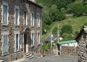 Road winding downhill through the village of Saint-Chély-d'Aubrac