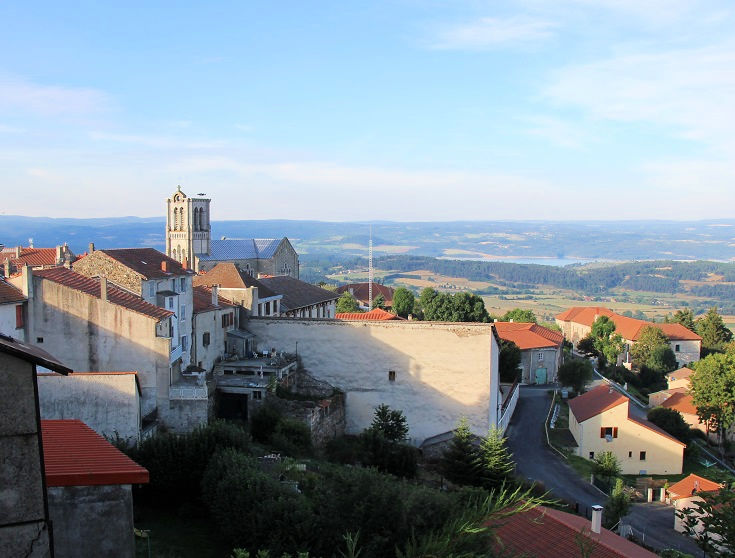View across the village and the roof of the church to countryside between Pradelles and Langogne